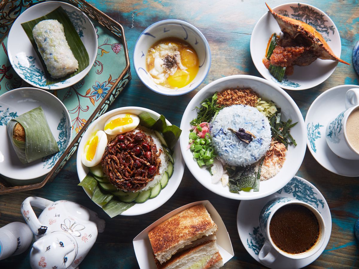 A tabletop filled with several delectable dishes at Kopitiam in New York City.