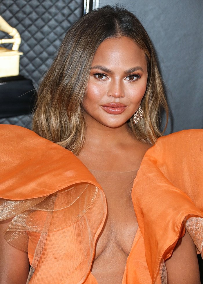 Chrissy Teigen's breasts peeking through her Yanina Couture dress at the 62nd Annual GRAMMY Awards on January 26, 2020