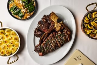 Immerse in the marvelous presence of The Lamb’s Club's porterhouse surrounded by a variety of sides.