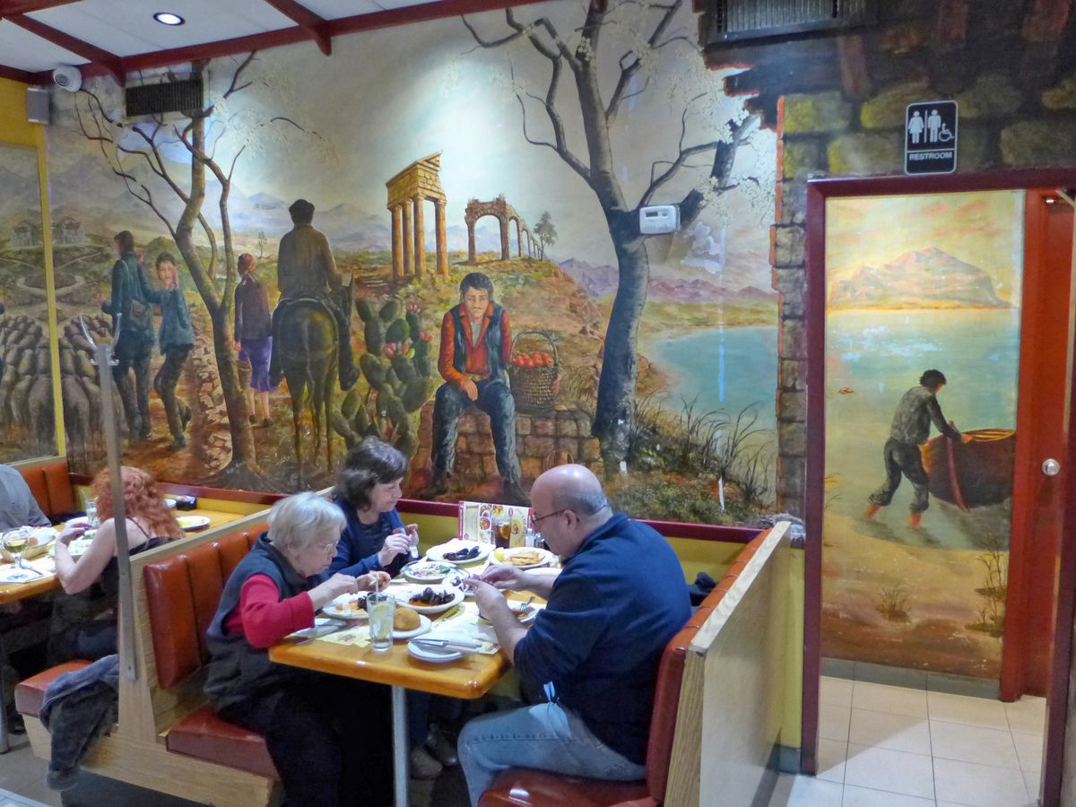 The dining room of Joe’s of Avenue U is lined with Sicilian murals.