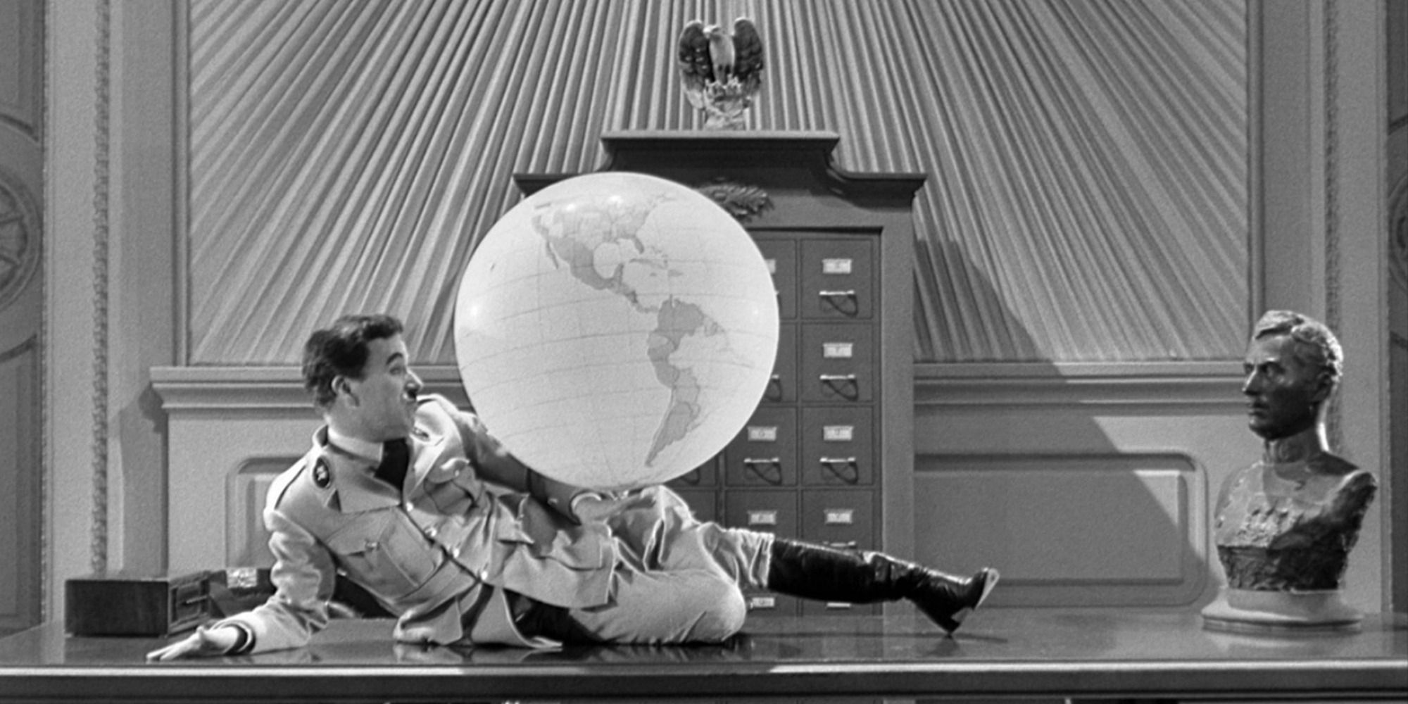 a man with a military uniform playing with a globe balloon on his desk