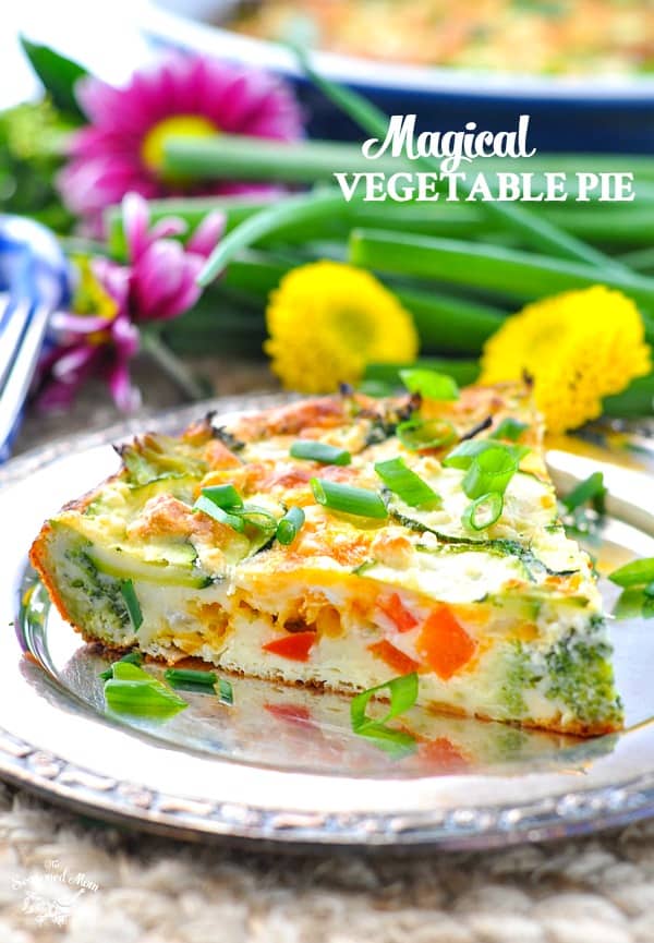 a slice of vegetable pie on a metal plate with flowers in the background