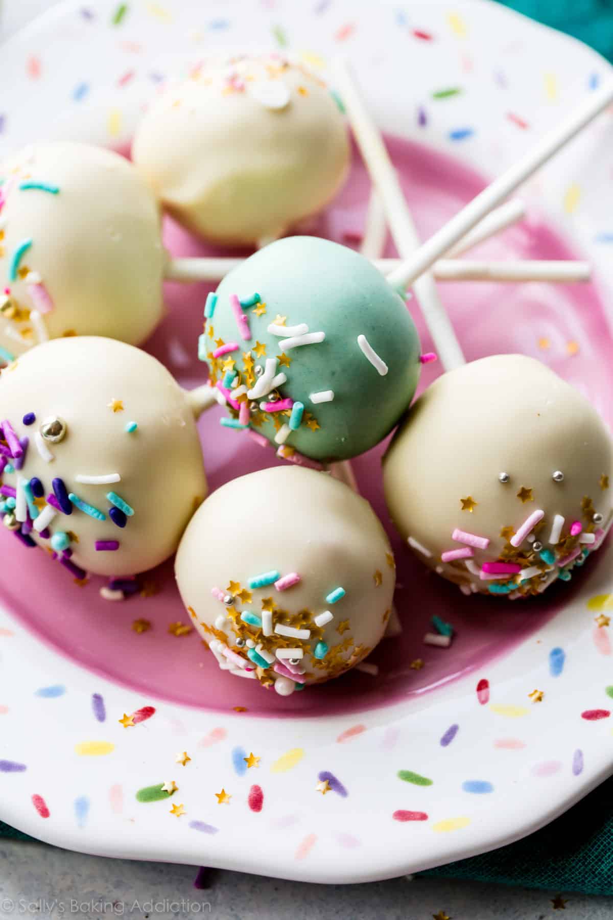 vanilla cake pops on a sprinkle plate