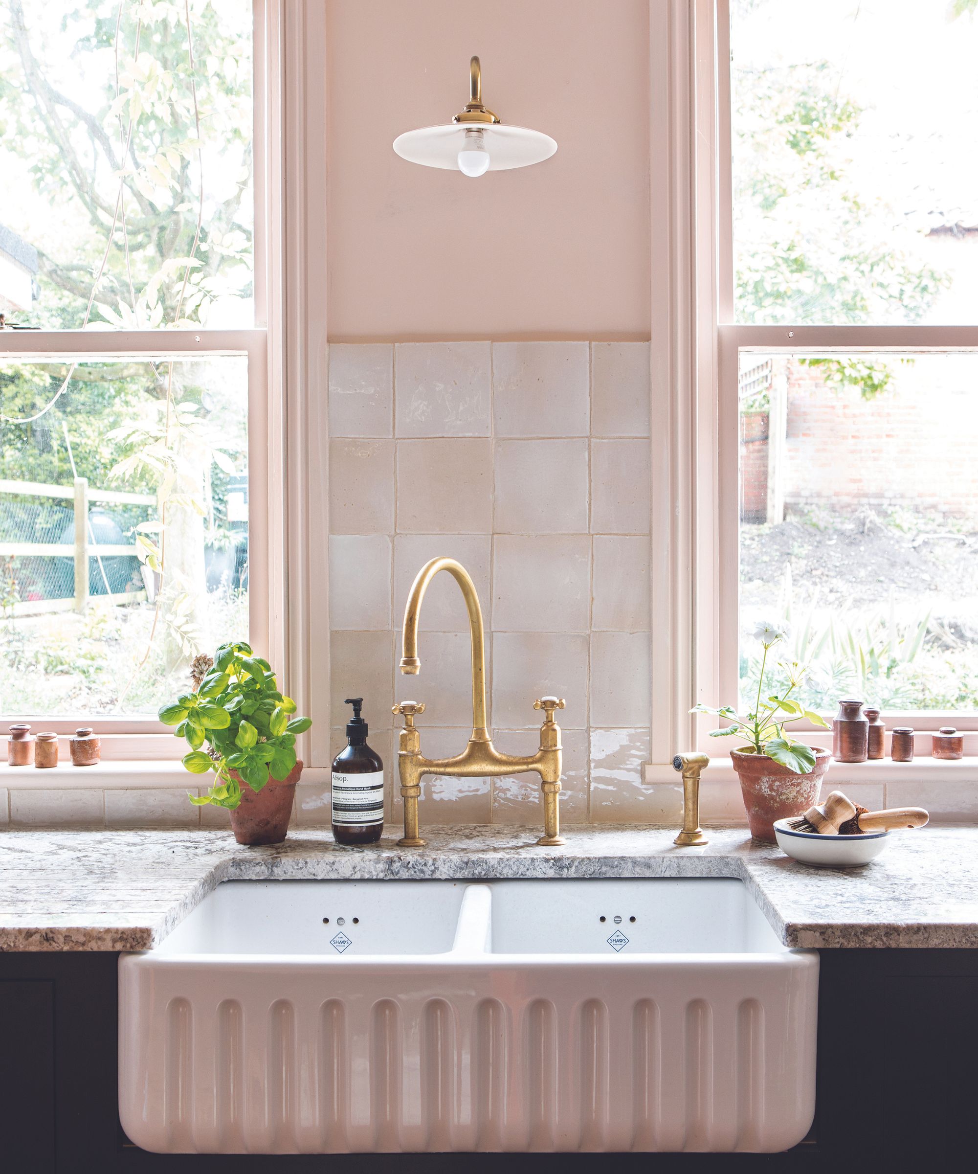 White kitchen sink, black cabinet, white tiles